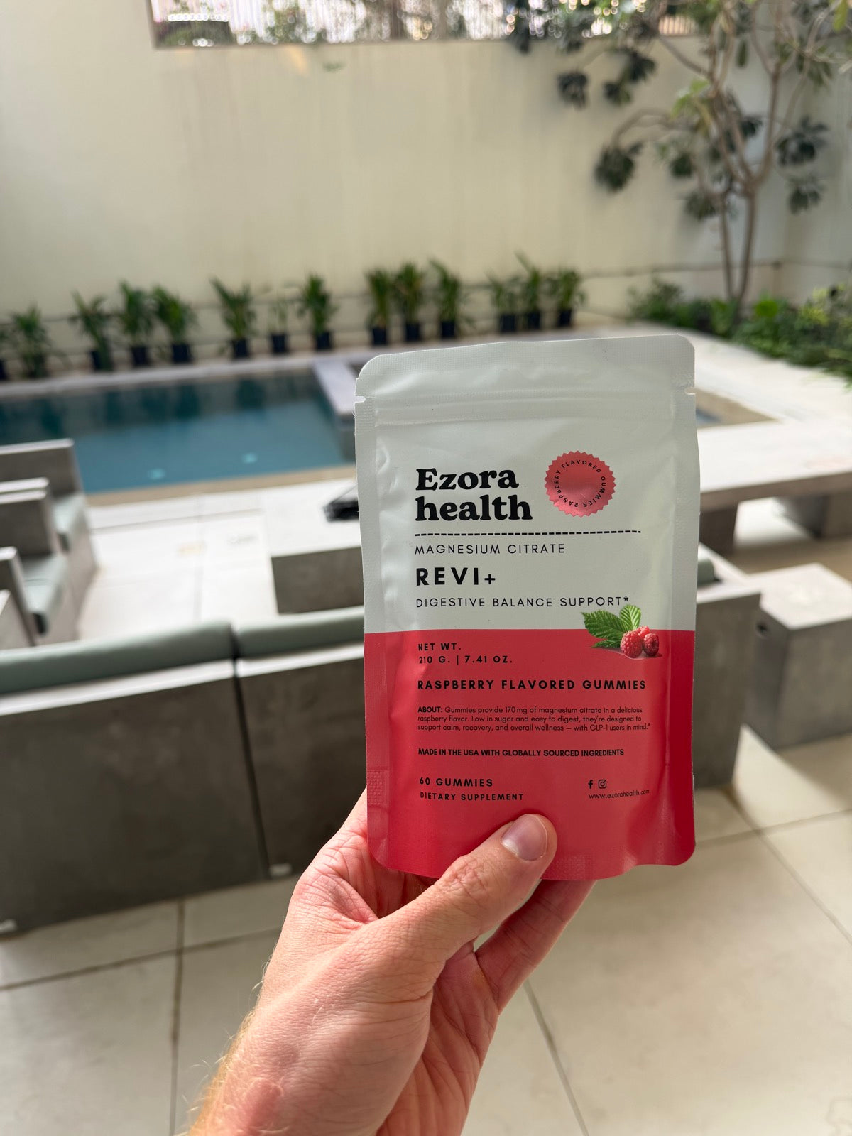 Woman relaxing with Revi+ Magnesium gummies — better sleep, calmer evenings